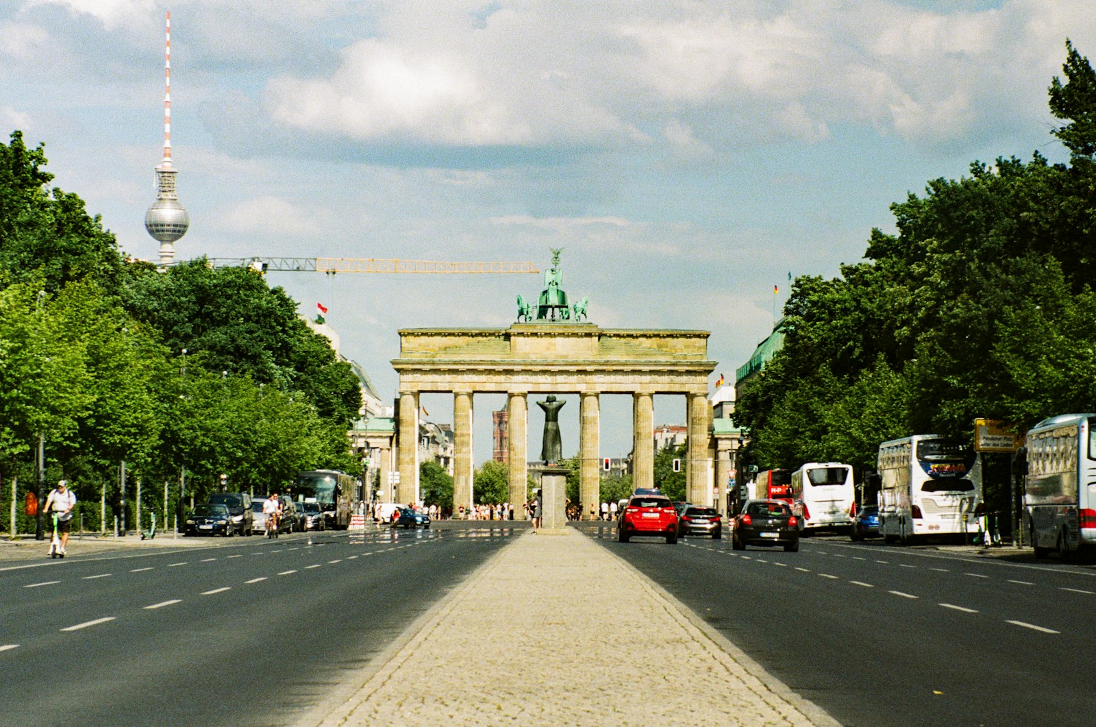 Brandenburg Gate in Berlin, Germany, with the television tower visible above the trees